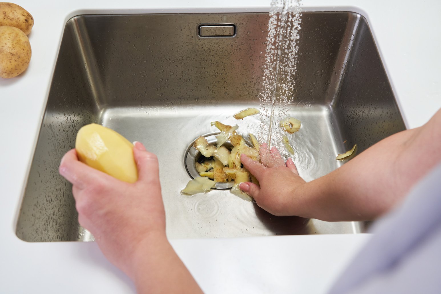 Food Waste Disposer Machine in Sink in Modern Kitchen